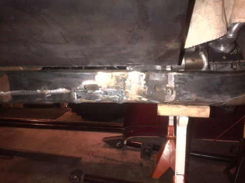 1985 Jeep CJ7 - Close-up of a vehicle's frame undergoing repair work, showing welded sections and structural supports.