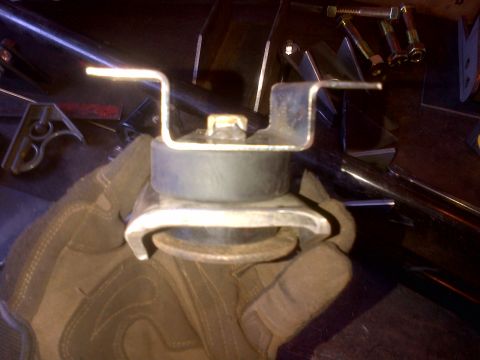 1985 Jeep CJ7 - A close-up view of a vehicle engine mount part being held.