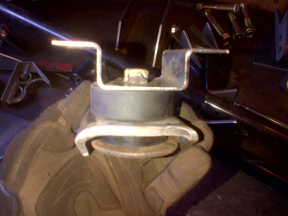 Engine mount part held by gloved hand