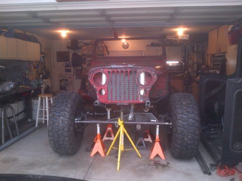 1985 Jeep CJ7 - This 1985 Jeep CJ7 is undergoing work in a garage, supported by jack stands.