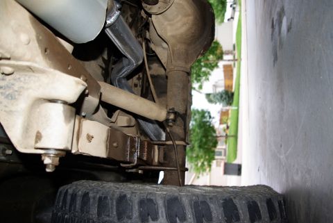 1995 Ford Bronco - Undercarriage view of a 1995 Ford Bronco, focusing on the rear axle and suspension system.