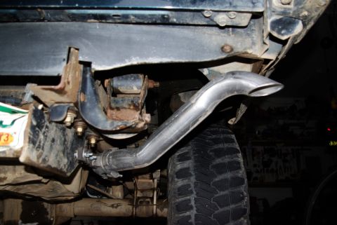 1995 Ford Bronco - Custom exhaust pipe installation on a vehicle. The year is not discernible from the image.