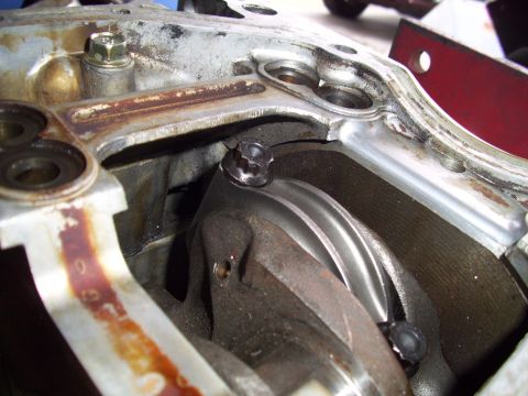 1995 Ford Probe - Close-up view of an engine's crankshaft and connecting rod, with a visible Supermotors.net watermark.