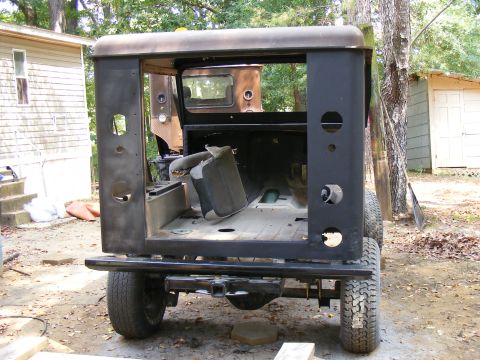 Back of a Jeep CJ-5 body, stripped down. Another vehicle is behind it