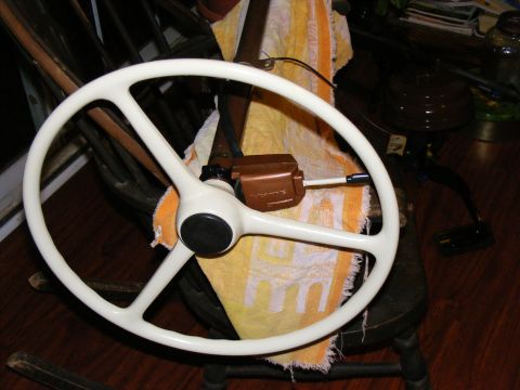 White steering wheel with a brown control box on the column, resting on a towel