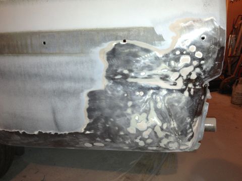 1964 Ford Fairlane - Bodywork in progress on a vehicle's rear section, showing areas of filler and primer.