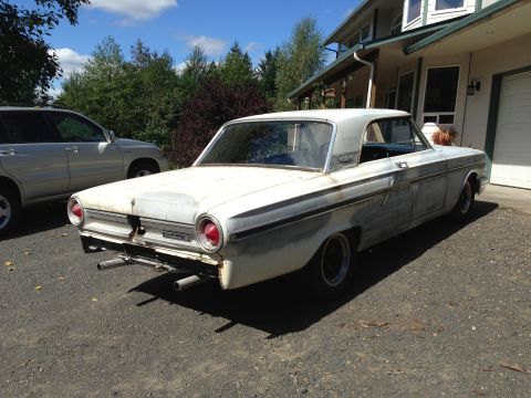 1964 Ford Fairlane - Rear view of a 1964 Ford Fairlane parked in a driveway next to an SUV.
