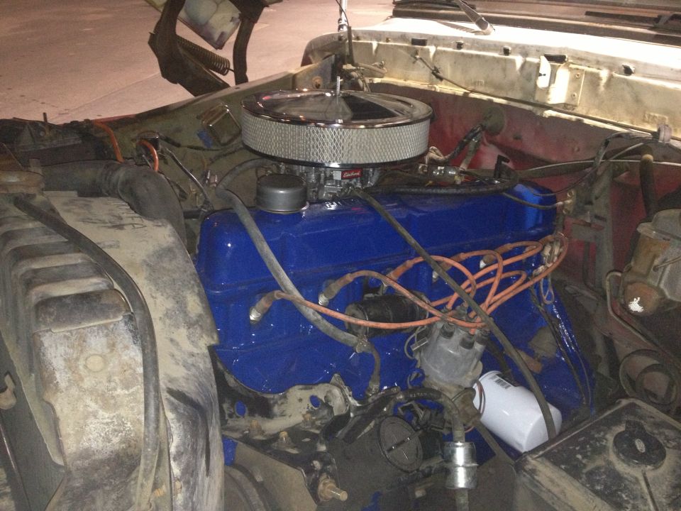 Engine bay with blue painted valve covers, chrome air cleaner, and orange spark plug wires