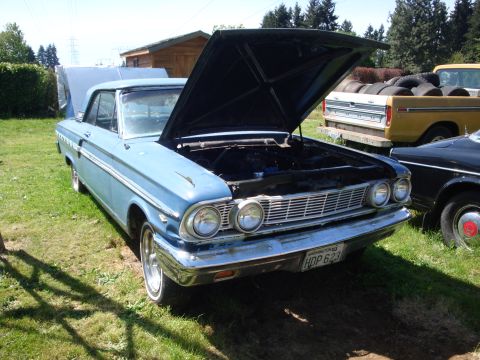1964 Ford Fairlane - Front view of a blue 1964 Ford Fairlane with its hood open, parked outdoors.