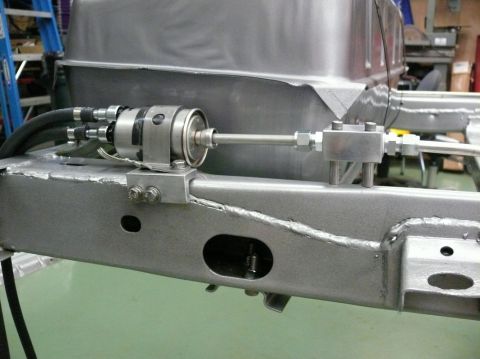 1976 Chevrolet Corvette - A close-up view of a fuel filter and its associated plumbing mounted to a vehicle's chassis.