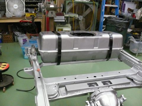 1976 Chevrolet Corvette - A silver fuel tank is mounted to a bare metal chassis in a workshop setting.