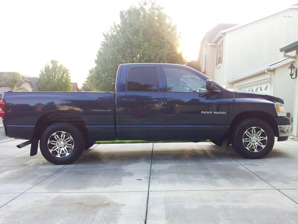 Dark blue 2007 Dodge Ram 1500 pickup truck with custom chrome wheels parked on a driveway.