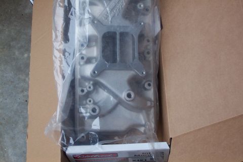 1980 Ford Bronco - A new Edelbrock intake manifold is shown in its packaging, ready for installation.