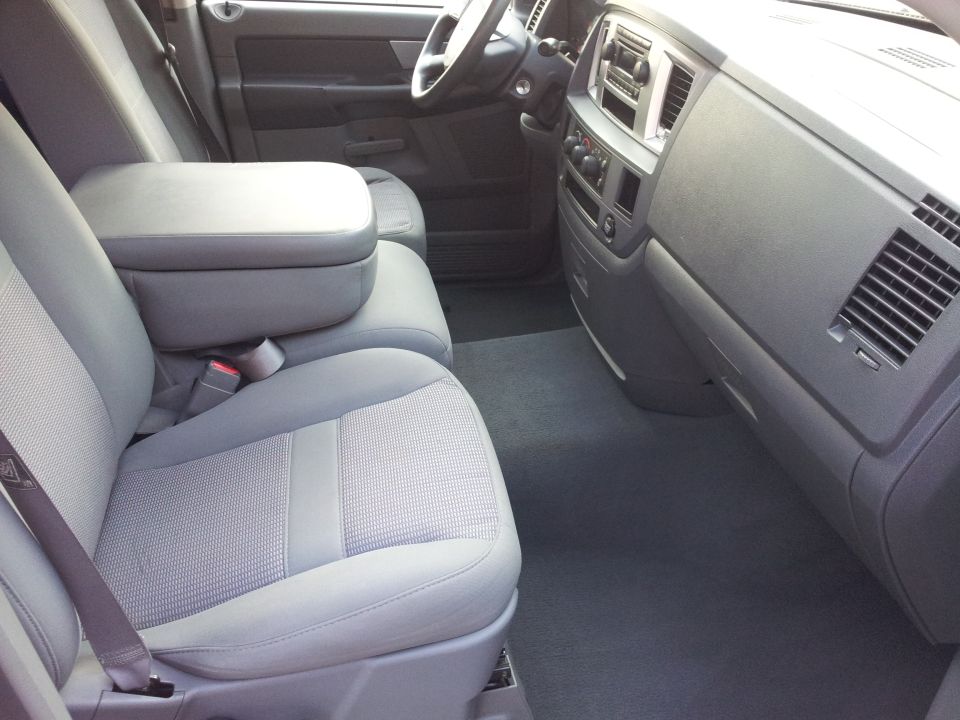 Interior of a pickup truck showing passenger seat, center console, and dashboard.