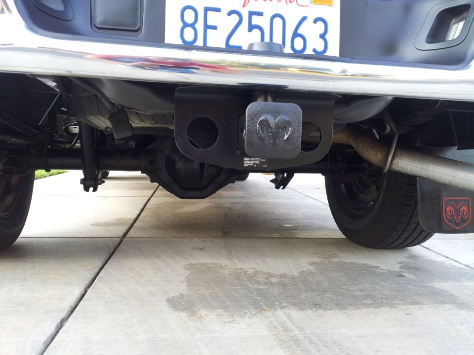 Pickup truck rear axle, bumper, and license plate. Chrome bumper is slightly dirty