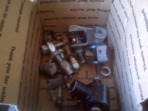 1985 Jeep CJ7 - A collection of vehicle parts is shown inside a cardboard box with shipping labels.