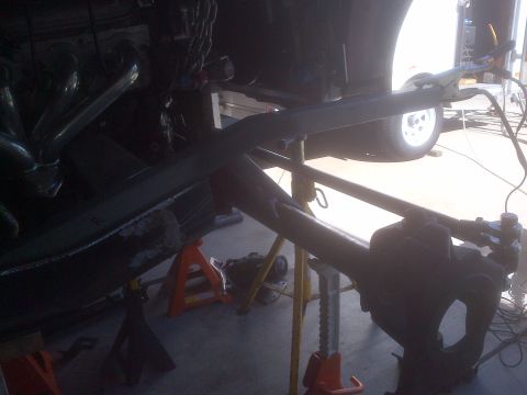 1985 Jeep CJ7 - Vehicle frame and suspension components are elevated on jack stands for maintenance or repair.