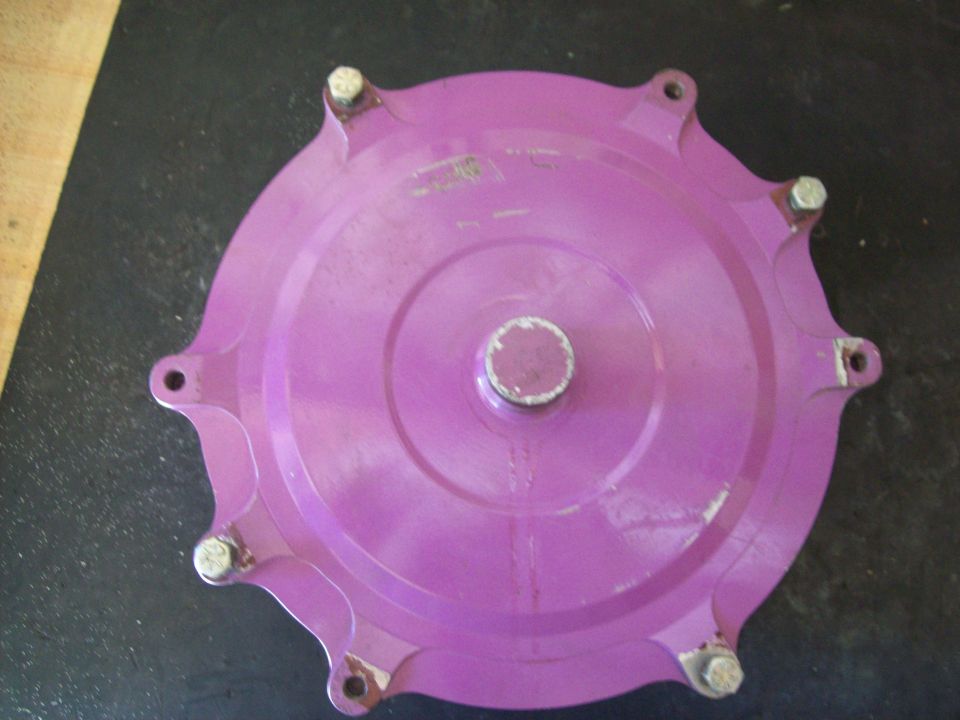 Purple transmission cover with six bolts and a central shaft