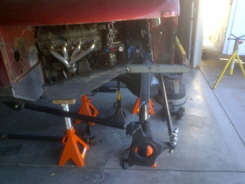 1985 Jeep CJ7 - A Jeep CJ is parked under a roofed area, supported by an orange jack.