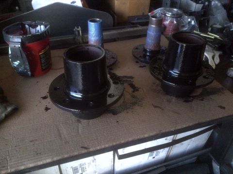 1985 Jeep CJ7 - Automotive hubs are prepared for installation, with one can of paint nearby.