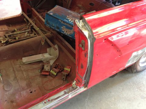 1964 Ford Fairlane - The interior of a car is shown during a restoration project, with parts removed and a new shifter box visible.