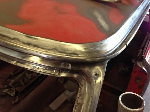 1964 Ford Fairlane - Car bodywork being prepped for paint, showing metal and primer layers.