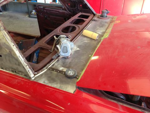 1964 Ford Fairlane - Dashboard and cowl area of a red 1964 Ford Fairlane undergoing restoration, with tools laid out on the metal.