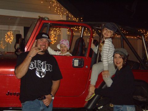 1985 Jeep CJ7 - Family poses with a red Jeep CJ7 during the holidays.