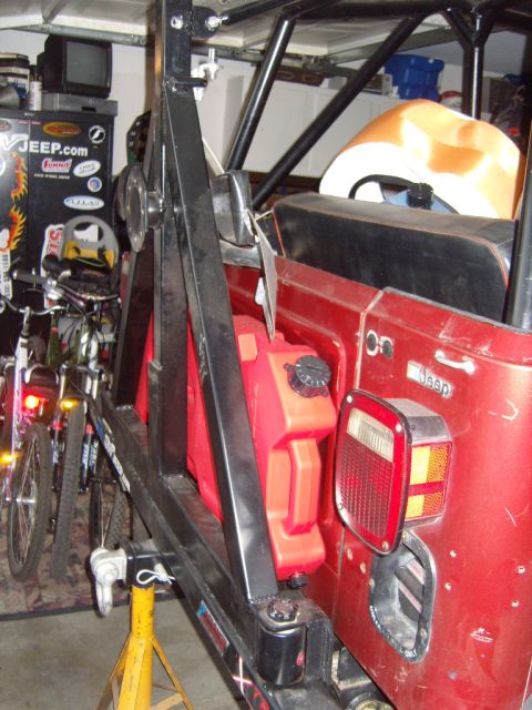 1985 Jeep CJ7 - Rear view of a 1985 Jeep CJ7, showing a mounted jerry can and roll cage.