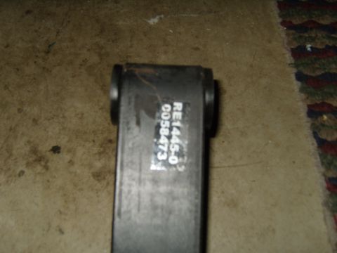 1985 Jeep CJ7 - A black metal part with visible part numbers and a website logo is shown against a textured background.