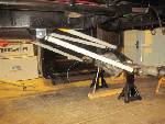 1985 Jeep CJ7 - The underside of a vehicle is captured while it is elevated on jack stands for maintenance or inspection.