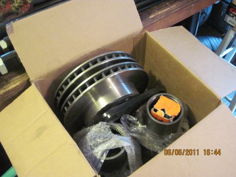 1985 Jeep CJ7 - New brake rotors and parts are shown inside a cardboard box.