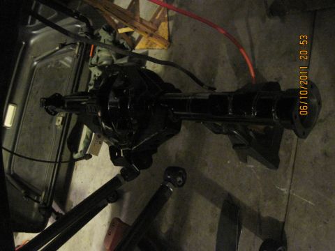1985 Jeep CJ7 - Rear axle assembly with suspension components is shown on a concrete floor.