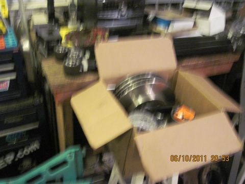 1985 Jeep CJ7 - New brake rotors are ready for installation, along with a small orange marker light.