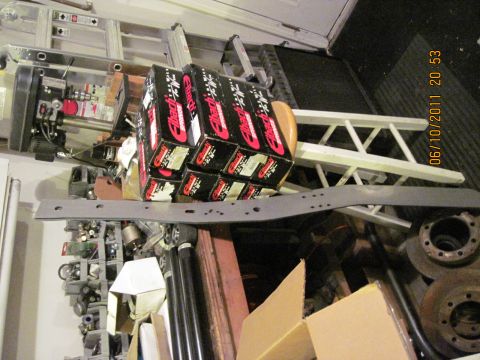 1985 Jeep CJ7 - A collection of automotive parts, including Eibach springs, is stored alongside ladders and other equipment.