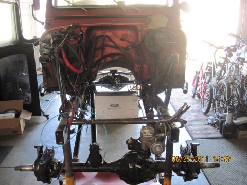 1985 Jeep CJ7 - Vehicle undergoing restoration with front end disassembled and drivetrain components visible.