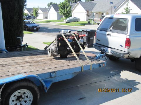 1985 Jeep CJ7 - Engine being transported on a trailer, hitched to a pickup truck.