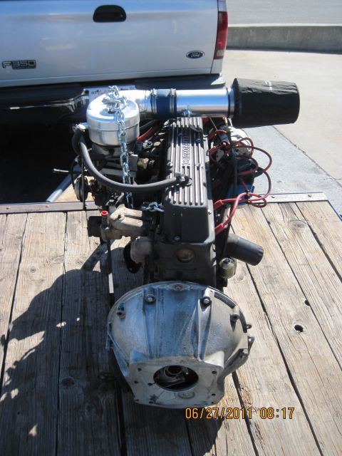 1985 Jeep CJ7 - Engine and transmission assembly, likely for a project vehicle, is loaded onto a trailer for transport.
