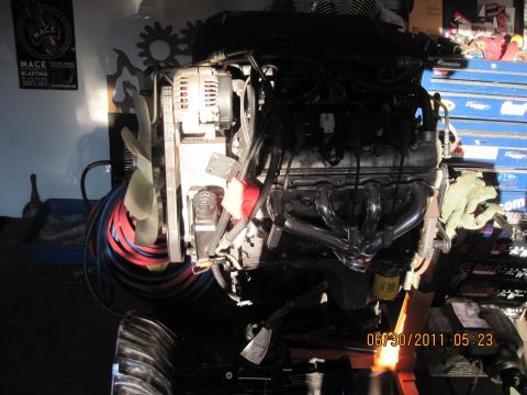 1985 Jeep CJ7 - Engine assembly with chrome headers and a visible fan, dated 06/30/2011.