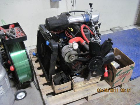1985 Jeep CJ7 - Engine assembly on a pallet, with a welding cart and parts box nearby. The photo was taken on June 30, 2011.