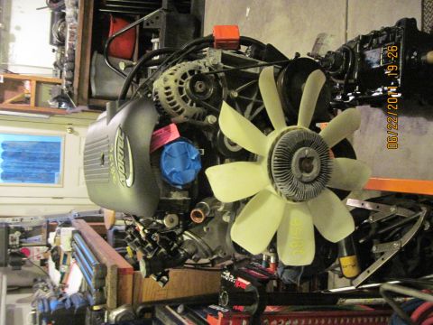 1985 Jeep CJ7 - Vortec engine assembly shown with fan and alternator. Date stamp visible on right side.