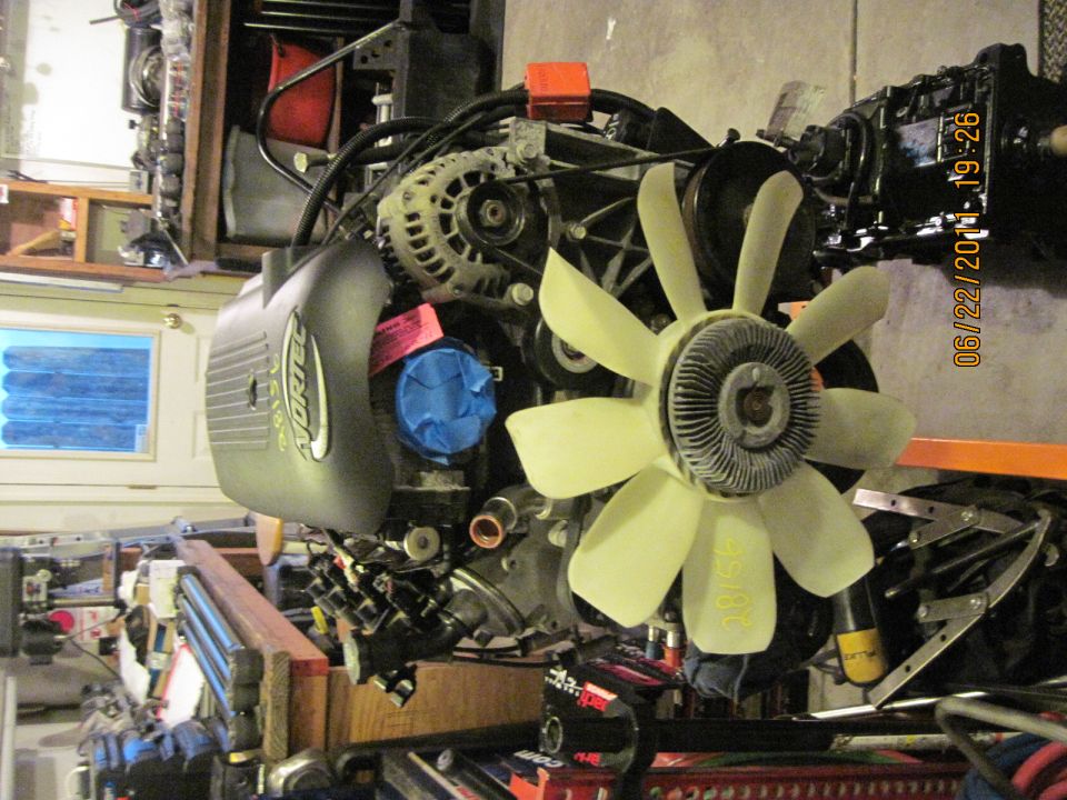 Vortec engine assembly with fan and alternator visible. Date stamp reads 06/22/2011