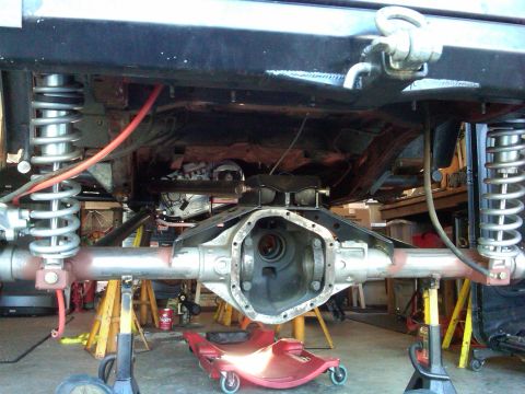 1985 Jeep CJ7 - Rear axle assembly of a Jeep undergoing work, with the differential housing open.