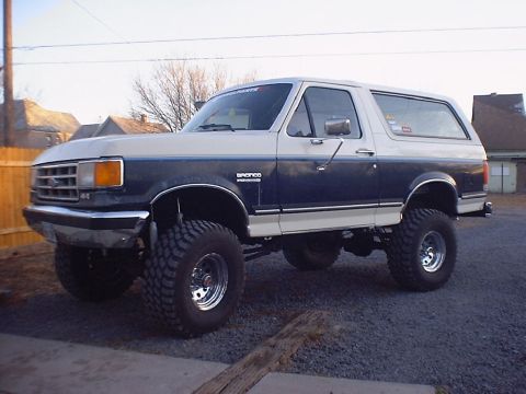 1988 Ford Bronco - This lifted Ford Bronco has a two-tone paint scheme and large off-road tires.