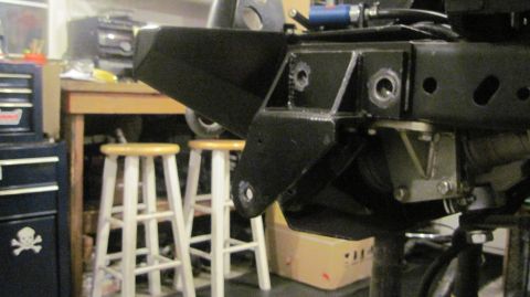 1985 Jeep CJ7 - Close-up of a Jeep's undercarriage, showing frame and suspension components.