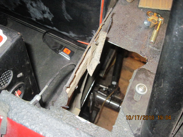 Interior floor damage reveals mechanical parts and a date stamp