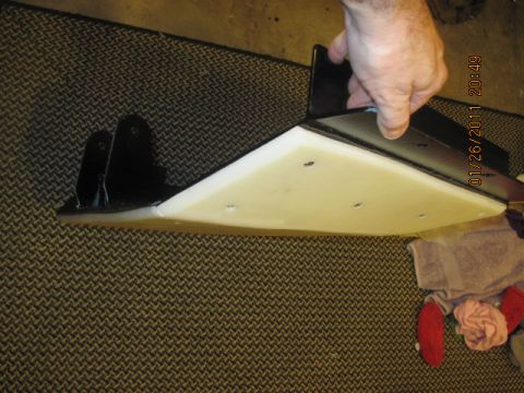 1985 Jeep CJ7 - A skid plate with mounting brackets is held by a hand over a patterned surface. Text at the bottom reads 'SUPERMOTORS.NET'.