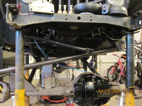 1985 Jeep CJ7 - Undercarriage view of a Jeep undergoing modifications, with suspension and drivetrain components visible.