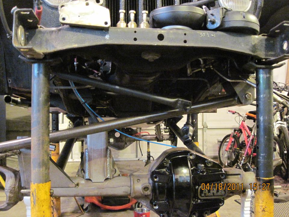 Jeep chassis on jack stands, showing suspension and differential work. Date stamp reads 04/18/2011
