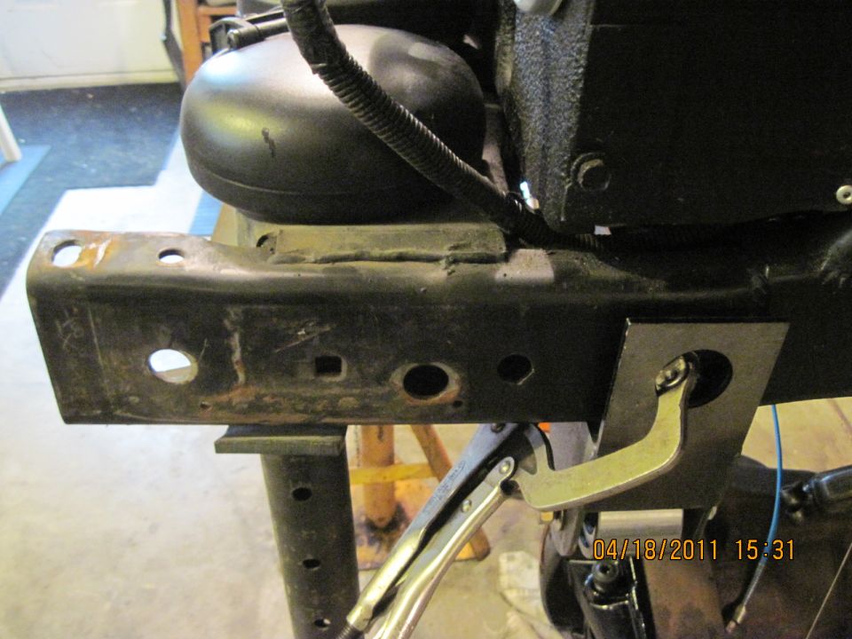 Close-up of vehicle frame with a clamp attached to a bracket